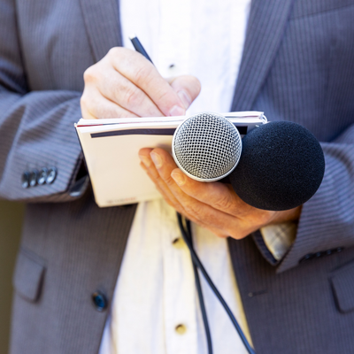 The image features a reporter holding two microphones. The image emphasizes the company's public relations service, which helps businesses build and maintain their public image through effective communication with media outlets and other stakeholders. The reporter in the photo represents the importance of having a positive relationship with the media, and Centipede Digital's service helps businesses achieve this goal. The image highlights the potential benefits of working with Centipede Digital to enhance the public perception of a business and improve its reputation.